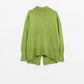 Loose green sweater with opening in the back