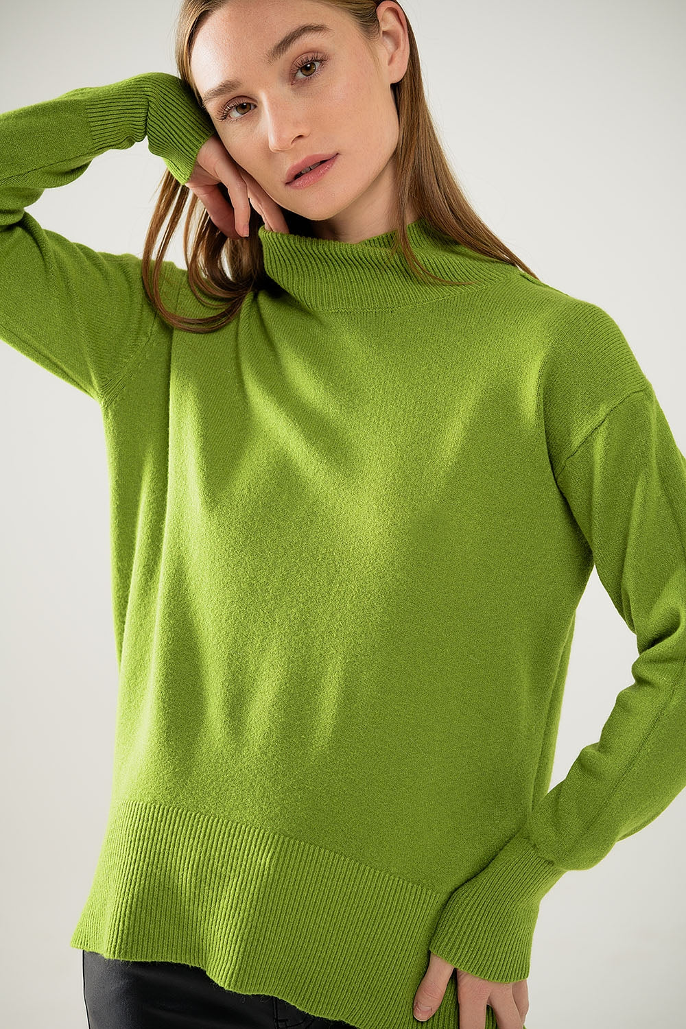 Loose green sweater with opening in the back