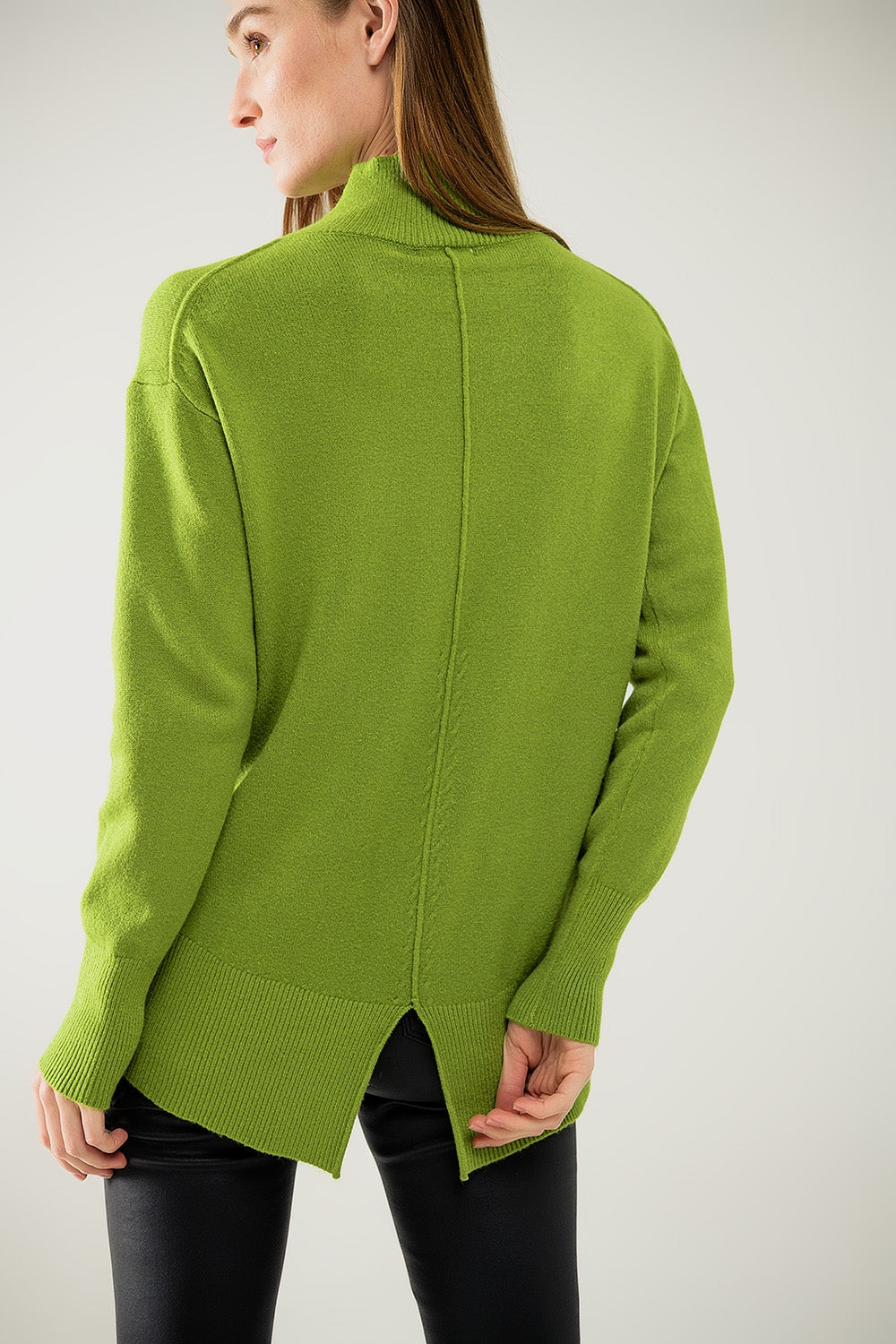 Loose green sweater with opening in the back