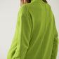 Loose green sweater with opening in the back