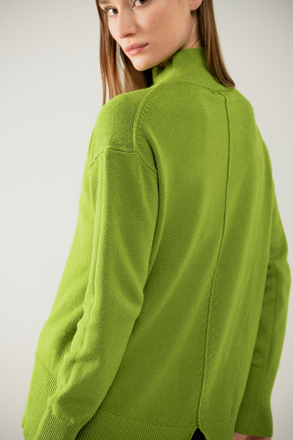 Loose green sweater with opening in the back