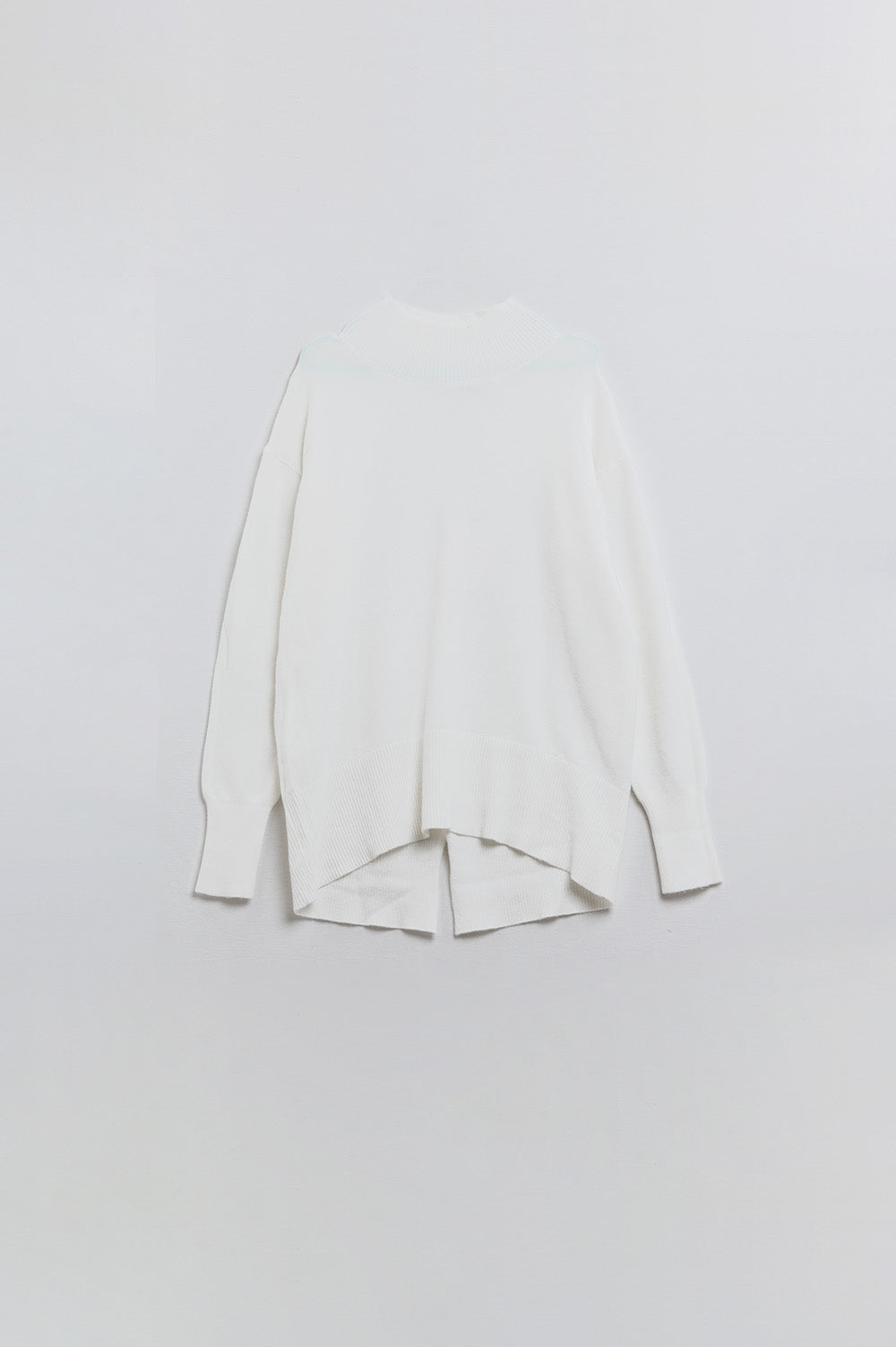 Loose white sweater with open back detail