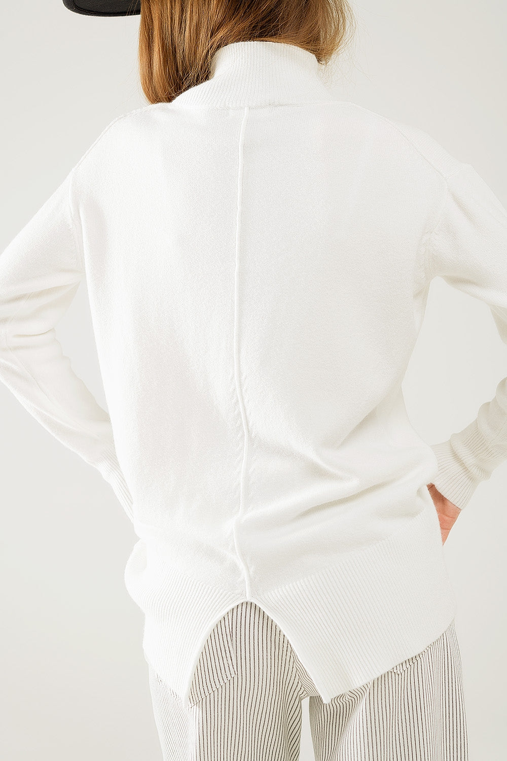 Loose white sweater with open back detail