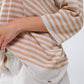 Oversized beige sweater with brown stripes and V-neck