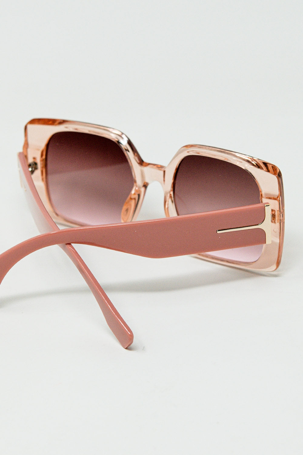 Pink square sunglasses with gold detail on the side