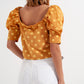 Polka dot top with puffed sleeves and square neckline in yellow