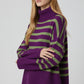 Purple oversized turtleneck sweater with green stripes and splits on the side
