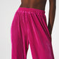 Pantalones anchos de raso con pliegues en fucsia