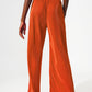 Satin pleated wide leg pants in orange