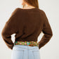 Short and fluffy brown cardigan with flower buttons