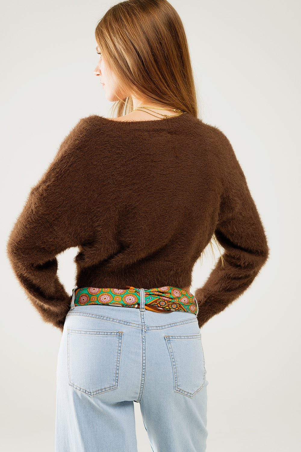 Short and fluffy brown cardigan with flower buttons