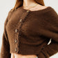 Short and fluffy brown cardigan with flower buttons