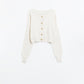 Short and fluffy cream cardigan with flower buttons