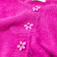 Short and fluffy pink cardigan with flower buttons