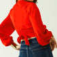 Short red crop top with long and wide sleeves