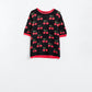 Q2 short sleeve black sweater with cherry print