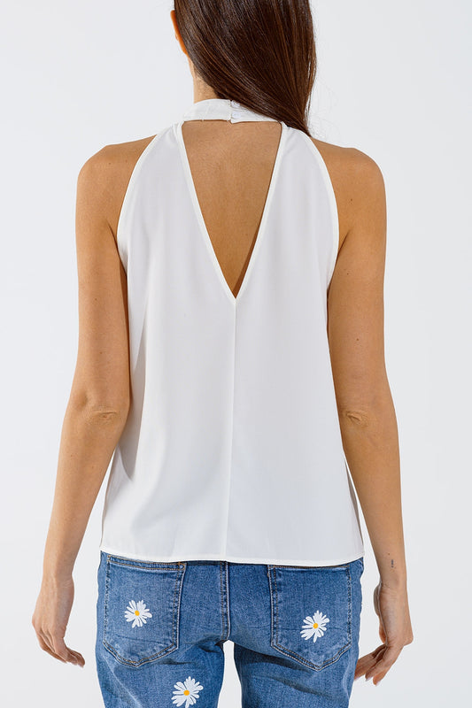 Sleeveless White Top with Ruffled Details and High Neck