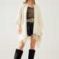 Soft knitted poncho in beige with fringes