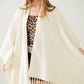 Soft knitted poncho in beige with fringes