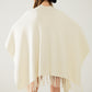 Soft knitted poncho in beige with fringes