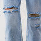 Sraight-leg jeans with exposed buttons and ripped knees in light wash