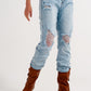 Straight leg distressed jeans with button detail in light blue