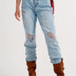 Straight leg distressed jeans with button detail in light blue