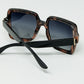 Sunglasses with a brown print frame and black temples