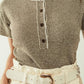 sweater with khaki stripes and gold button closure