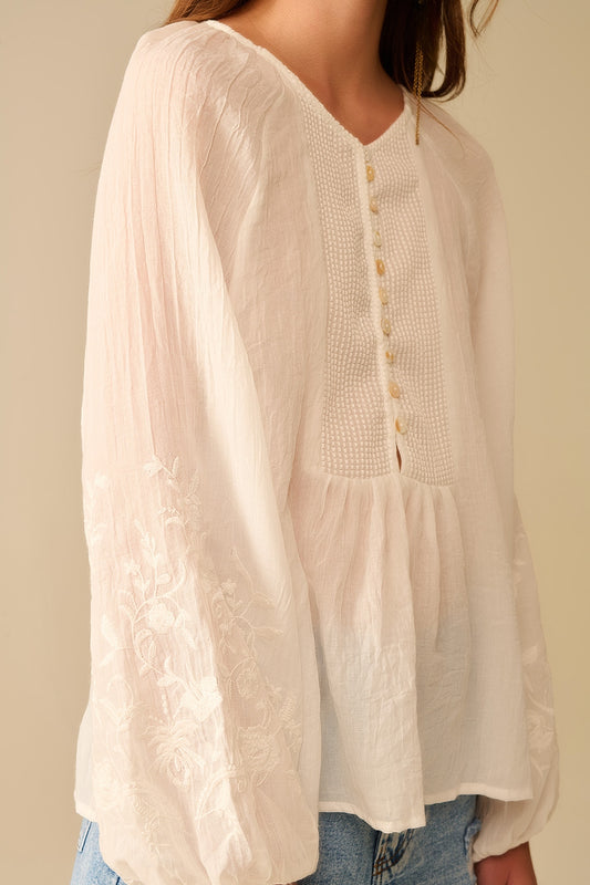 white chiffon blouse with embroidery on the sleeves