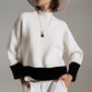 Q2 white jumper with black ribbed cuffs and hem