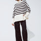 White oversized trutleneck sweater with black stripes and splits on the side