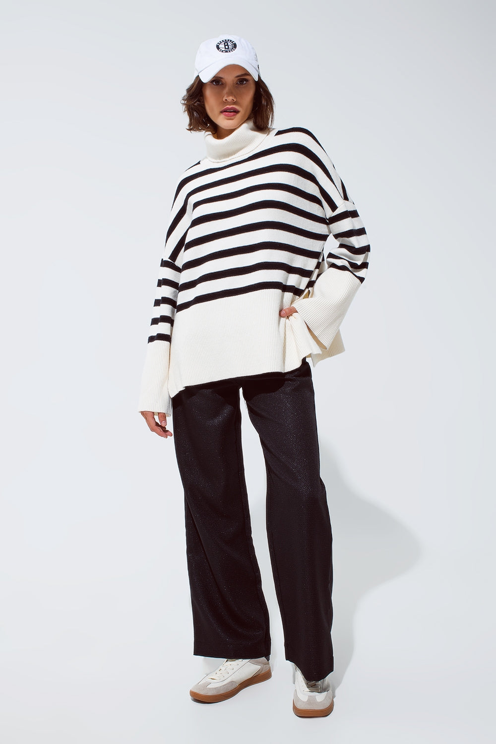 White oversized trutleneck sweater with black stripes and splits on the side