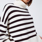 White oversized trutleneck sweater with black stripes and splits on the side