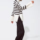 White oversized trutleneck sweater with black stripes and splits on the side