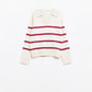 white sweater with dark red stripes and wide v neck