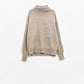 wide beige sweater with ribbed sleeves