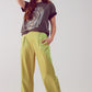 pantalones anchos de raso en acid lime