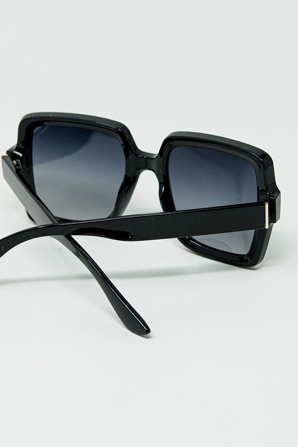 Wide square frame sunglasses with gold detail on the temples