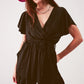 Wrap front frill hem jumpsuit in black