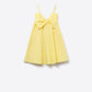 Yellow poplin mini dress with a big bow detail