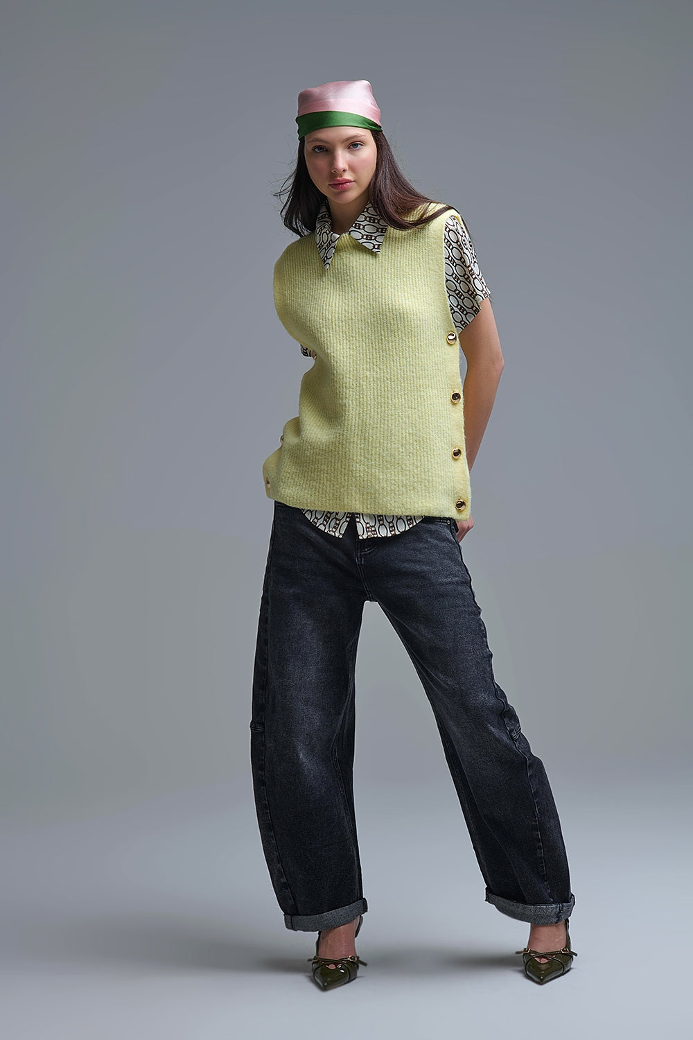 Yellow sleeveless sweater with gold buttons on side
