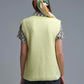 Yellow sleeveless sweater with gold buttons on side