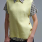 Yellow sleeveless sweater with gold buttons on side