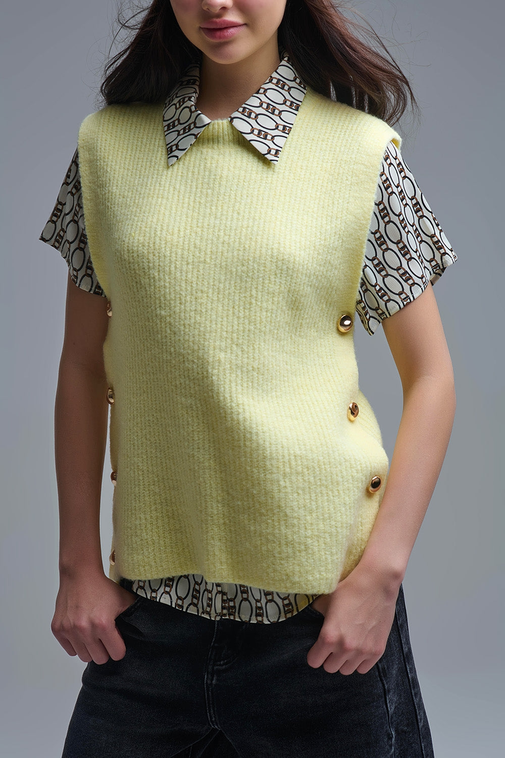 Yellow sleeveless sweater with gold buttons on side