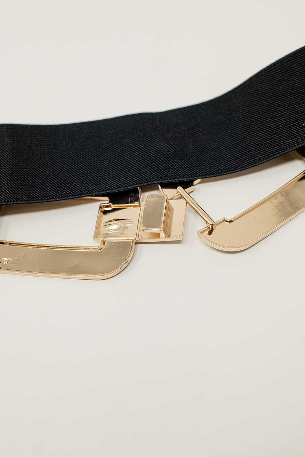 Cinturón elástico negro con doble hebilla ovalada con incrustaciones de strass