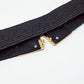 Black woven belt with square buckle with white and gold details