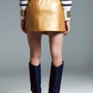 Faux leather mini skirt with bow on the side in gold