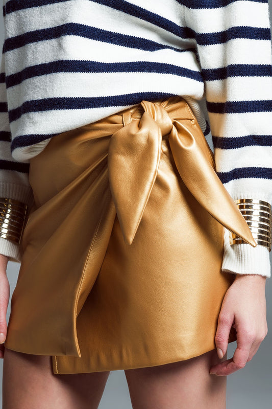 Faux leather mini skirt with bow on the side in gold