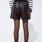 Faux leather oversized shorts with pleat down the front and pockets in black